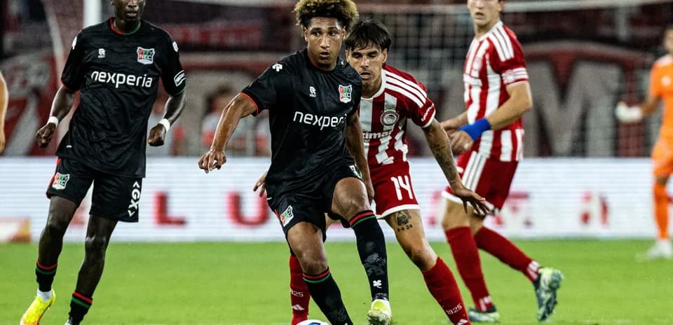 NEC Nijmegen player dribbling past Olympiakos defender