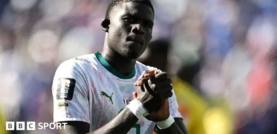 Player in national team jersey expressing determination