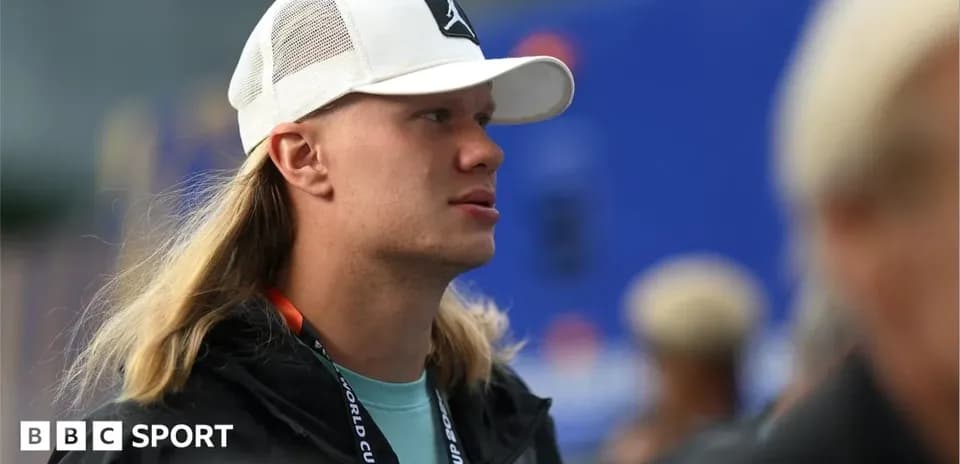 Athlete with long hair wearing a cap at event