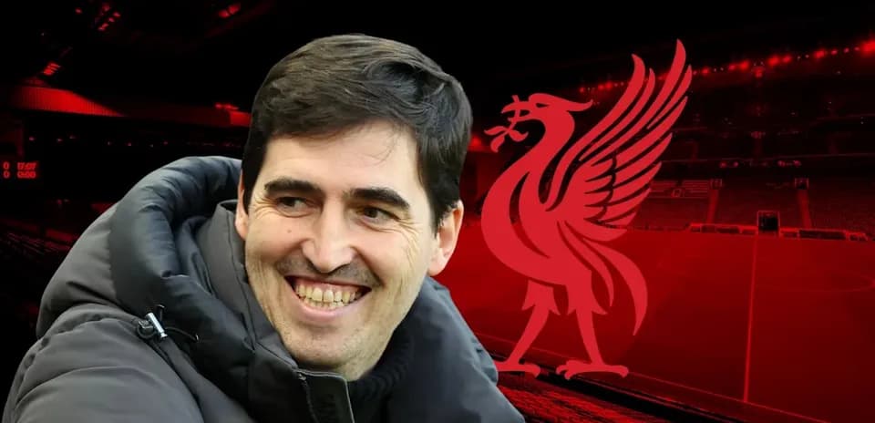 Coach smiling with Liverpool logo in background