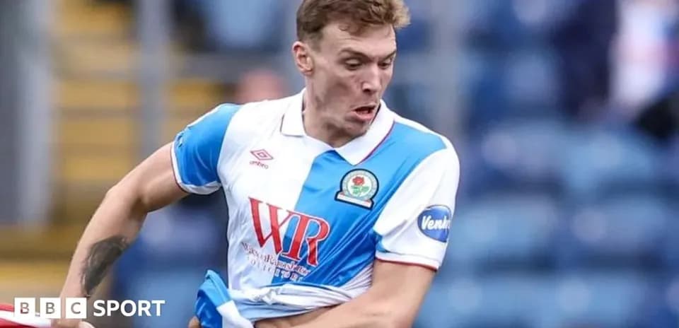 Player pulling at shirt during football match