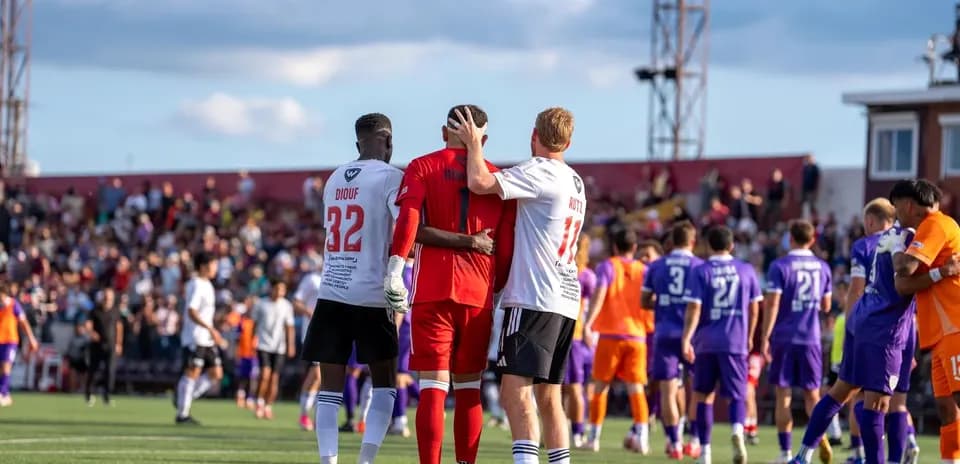 Players celebrating after a match conclusion