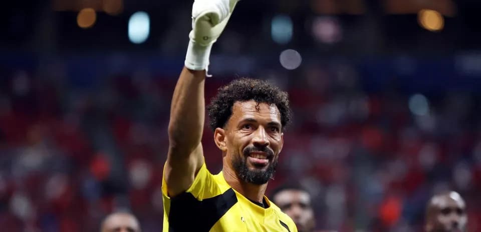 Goalkeeper celebrating with raised hand after match
