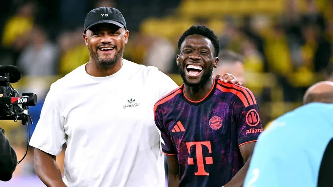 Two men laughing on the football pitch