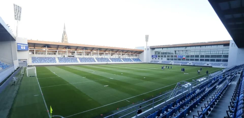View of stadium with players warming up on field
