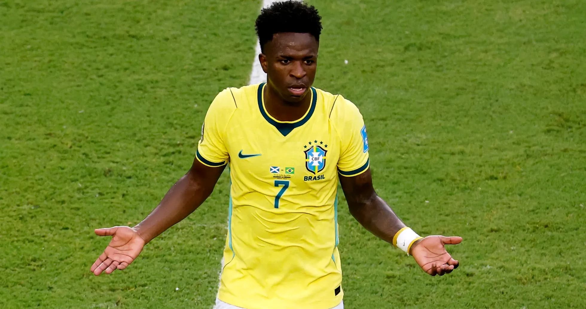 Player in yellow Brazil jersey gesturing on field