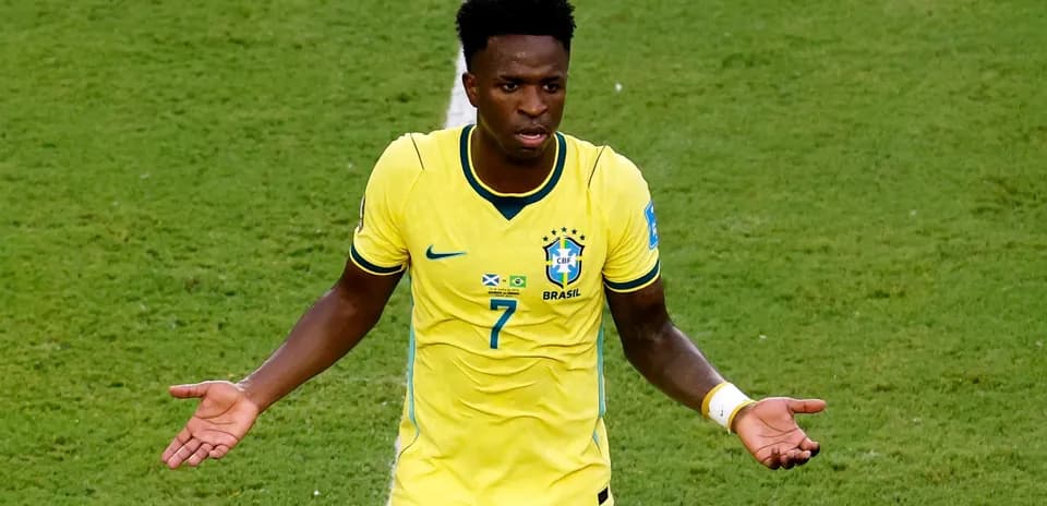Player in yellow Brazil jersey gesturing on field