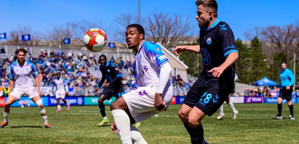 Players competing for the ball in football match