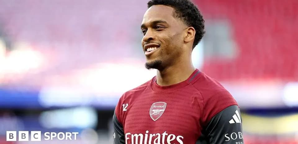 Player in Arsenal kit smiling on the pitch