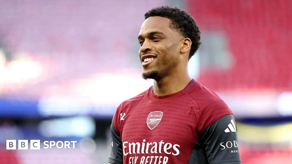 Player in Arsenal kit smiling on the pitch