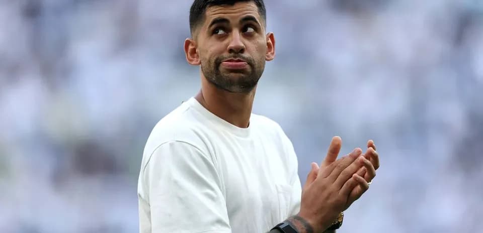 Player applauding in front of cheering crowd