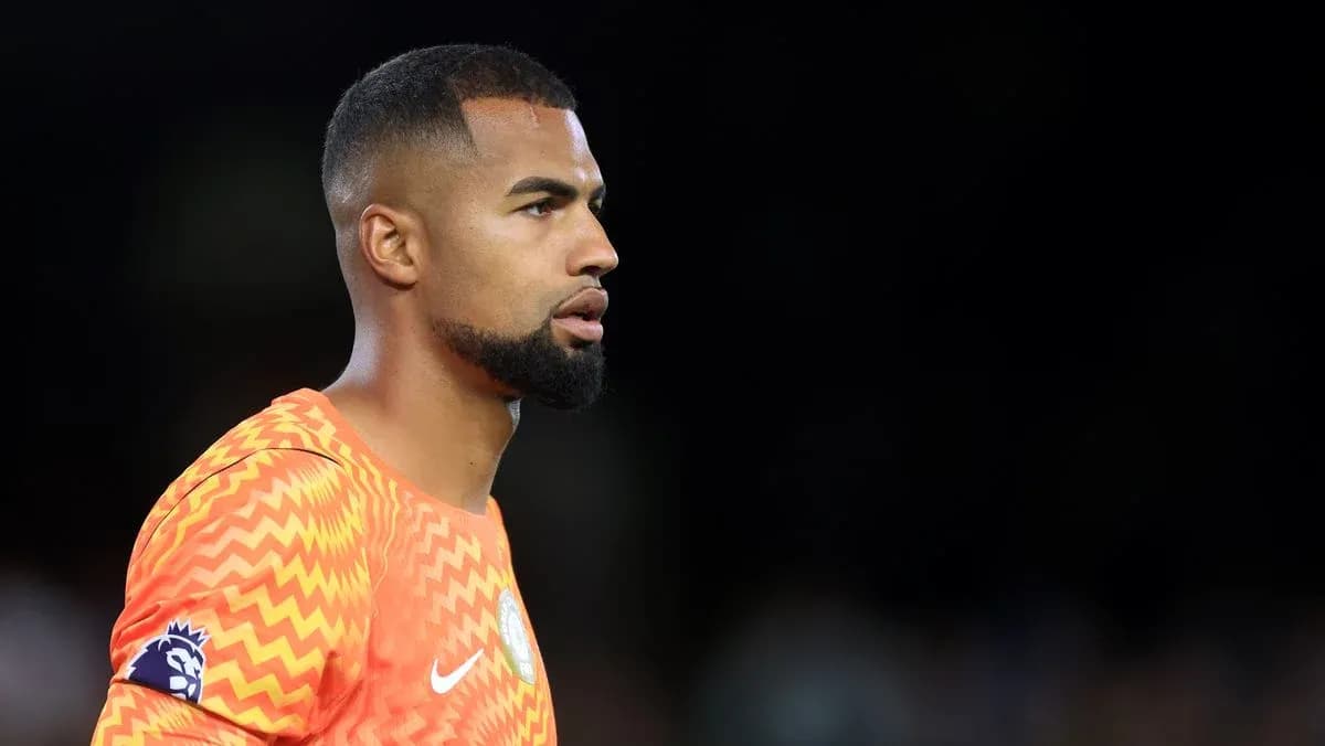 Goalkeeper in orange kit during match preparation