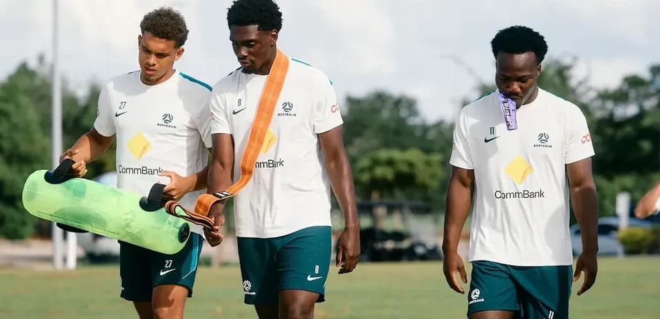 Players walking with training equipment during session