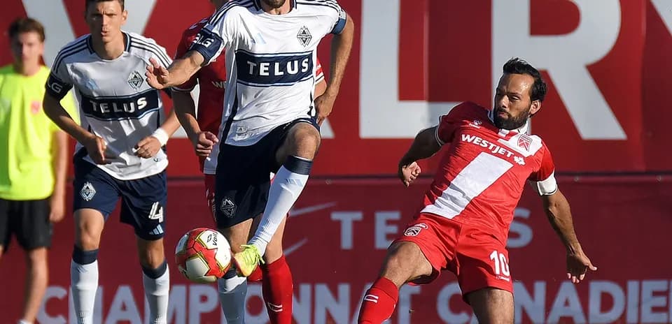 Vancouver FC player challenges Cavalry FC opponent