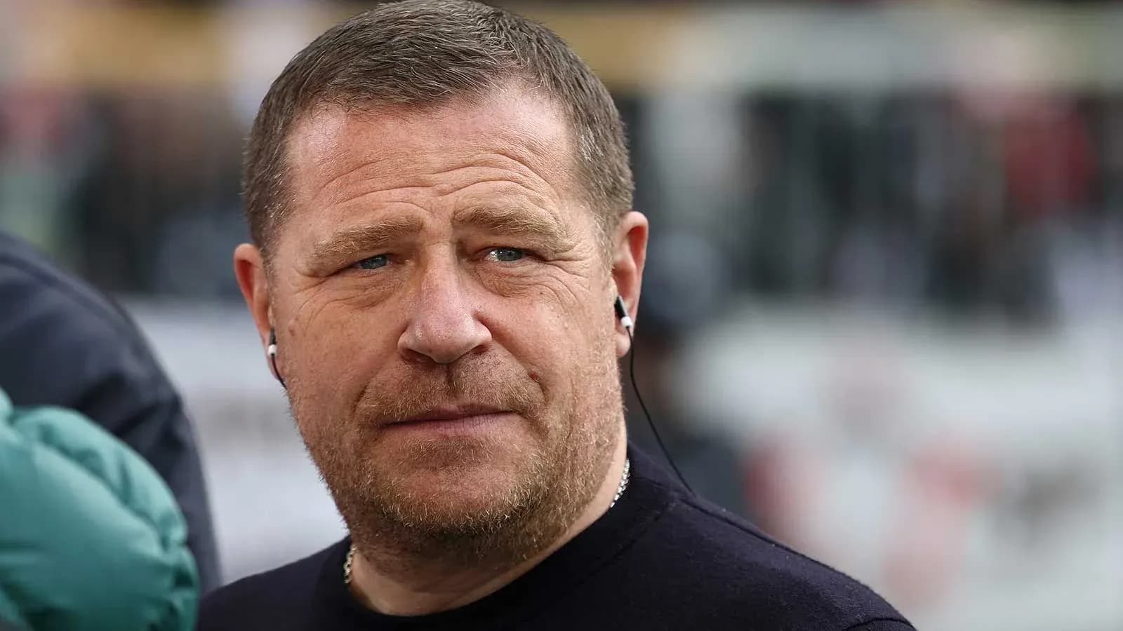 Man with earphones at sporting event venue