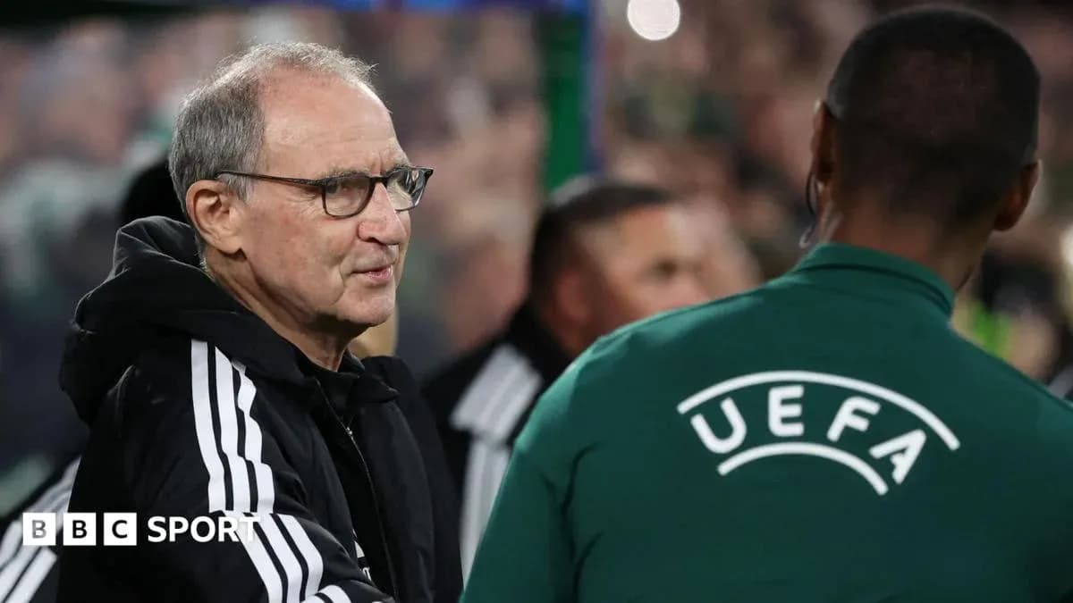 Coach interacting with UEFA official during match