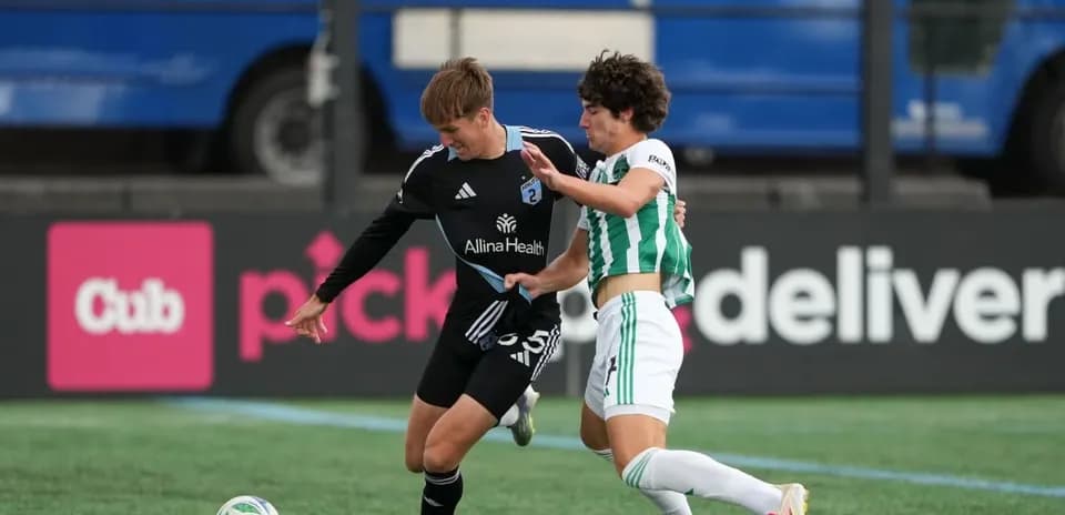 Players competing for the ball during MLS Next Pro match