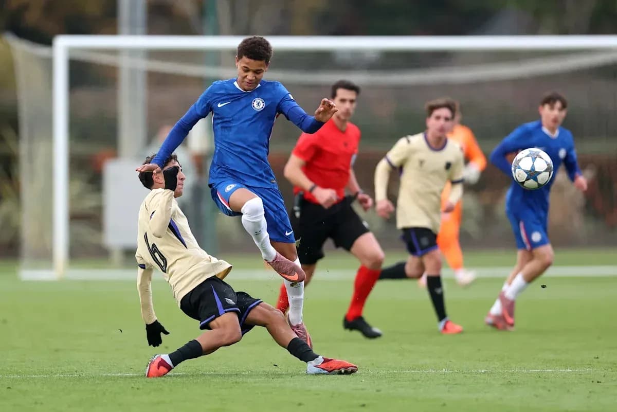 Player from Chelsea evading a sliding tackle during match