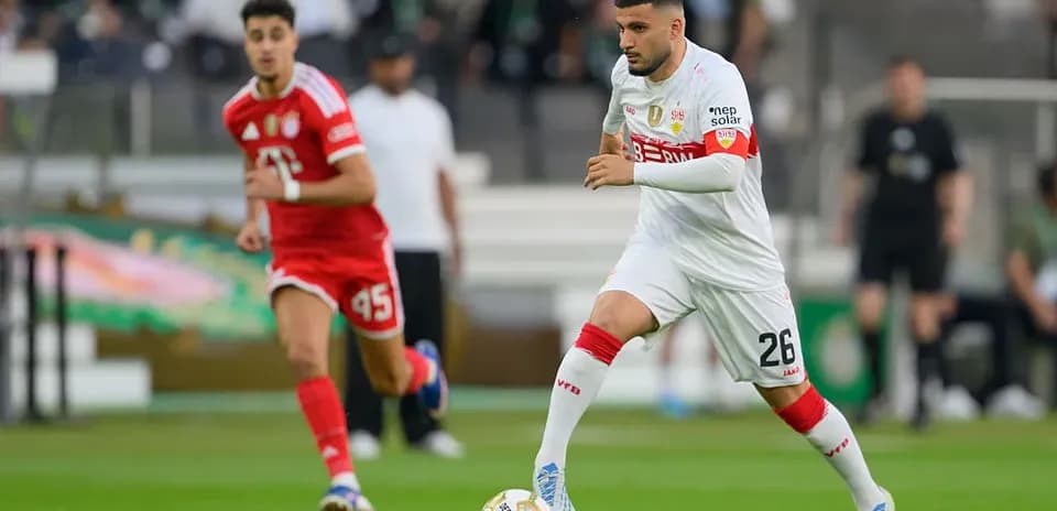 Player in white dribbling ball during match