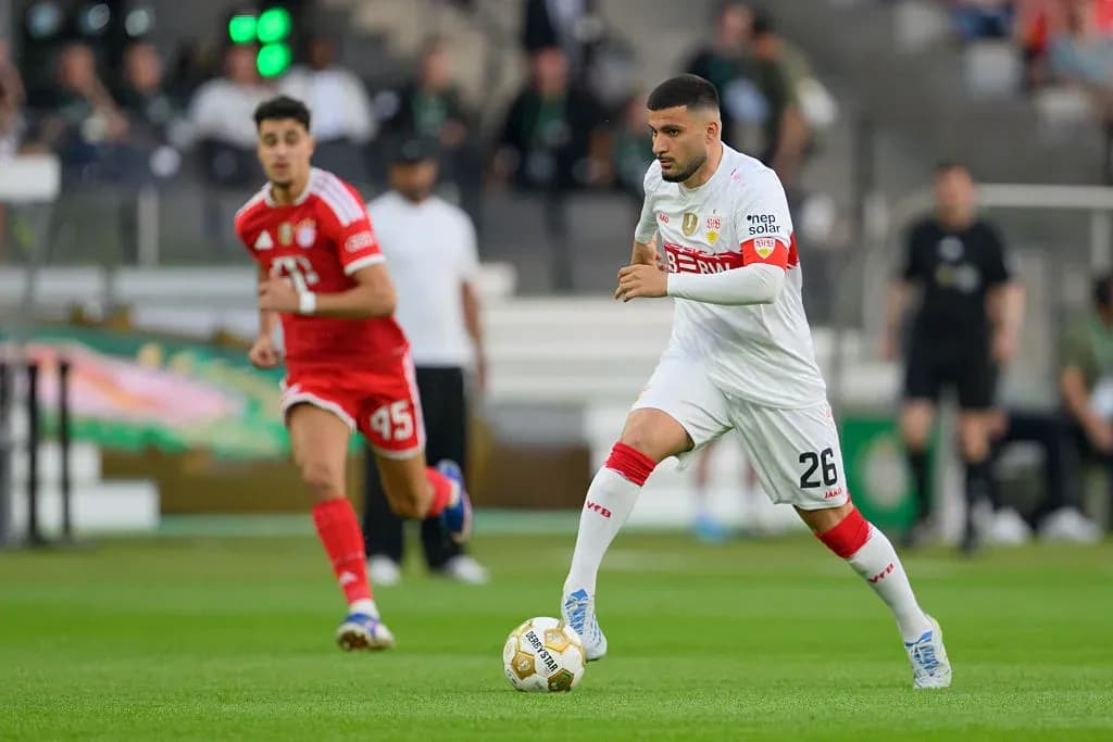 Player in white dribbling ball during match