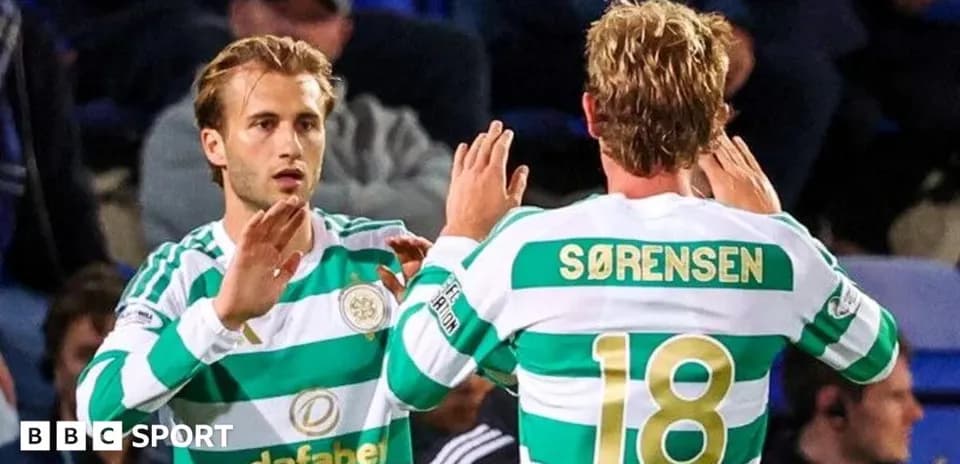 Two Celtic players celebrating on the pitch