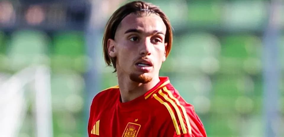 Player in red Spain jersey on football field