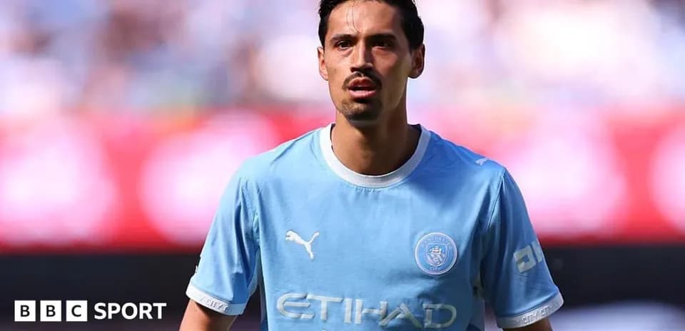 Player wearing light blue Manchester City jersey on field
