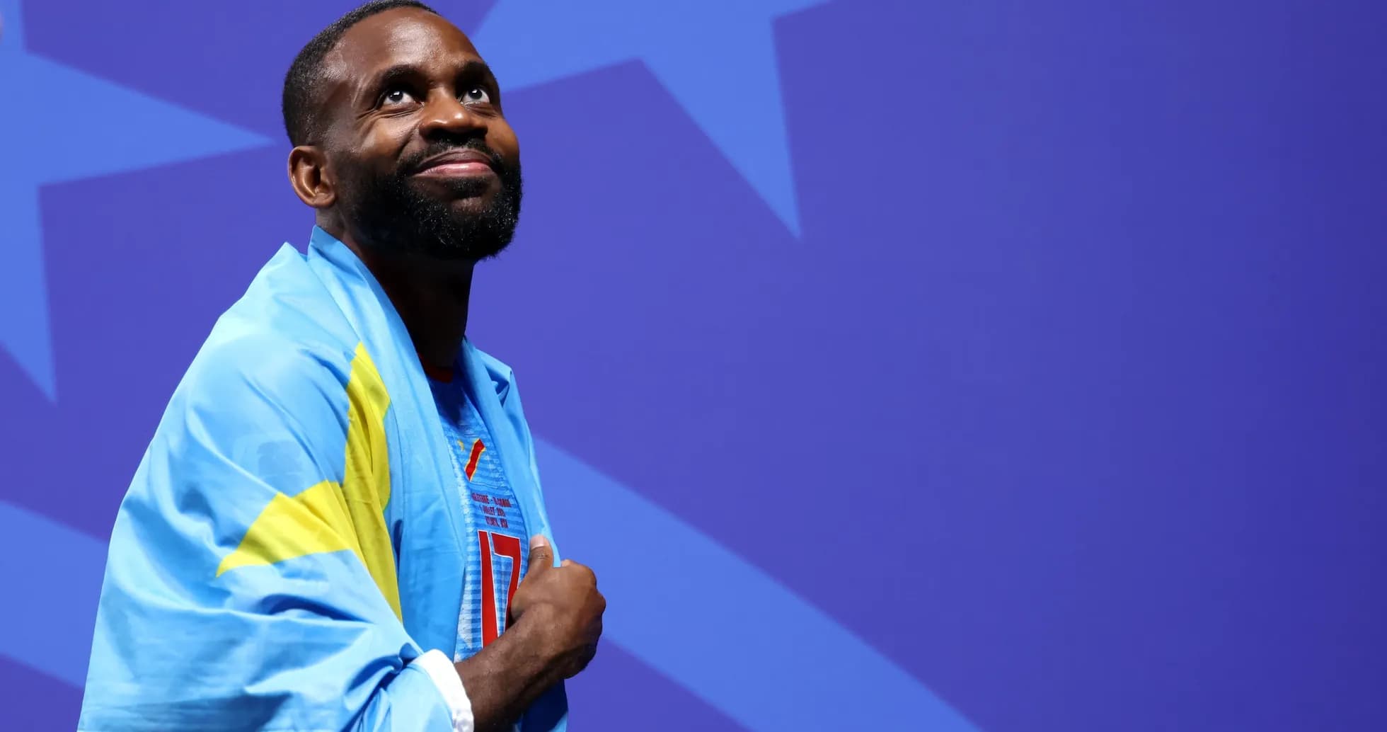 Athlete wearing flag celebrating on stage