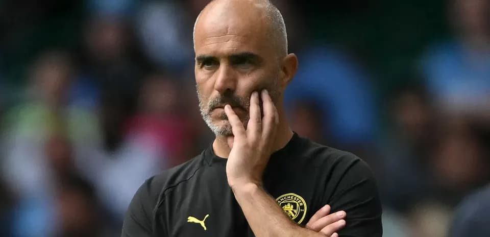 Coach observing the match with a thoughtful expression