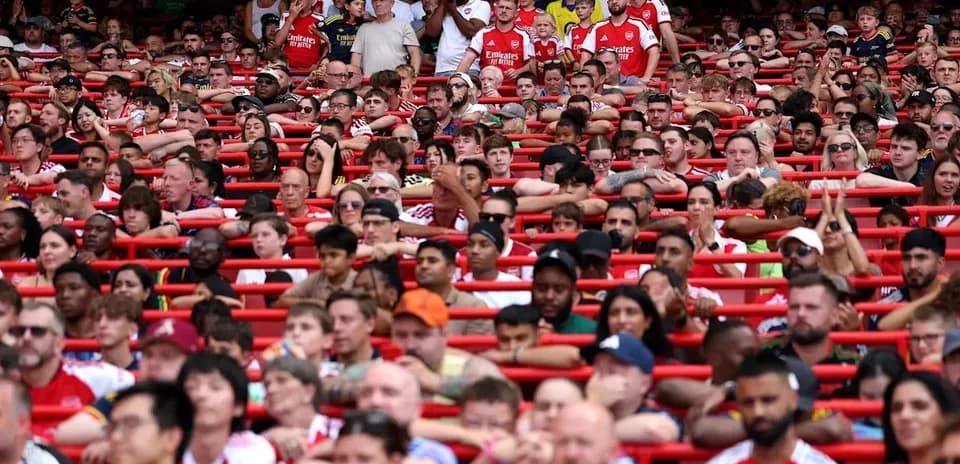 Crowd of Arsenal fans in stadium seats