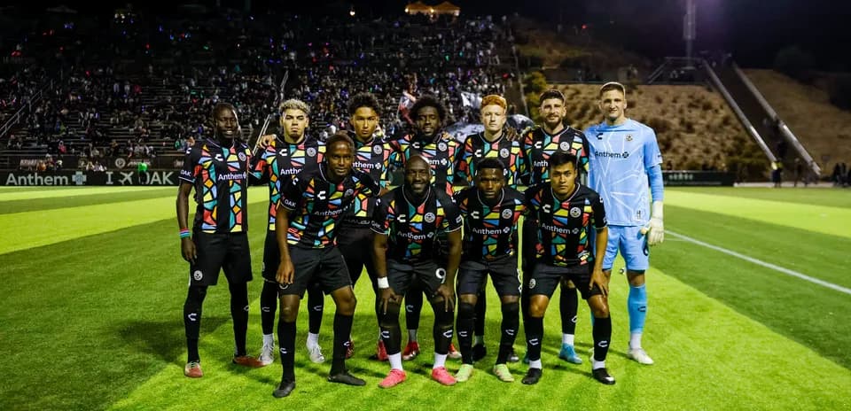 Oakland Roots team posing for photo before match