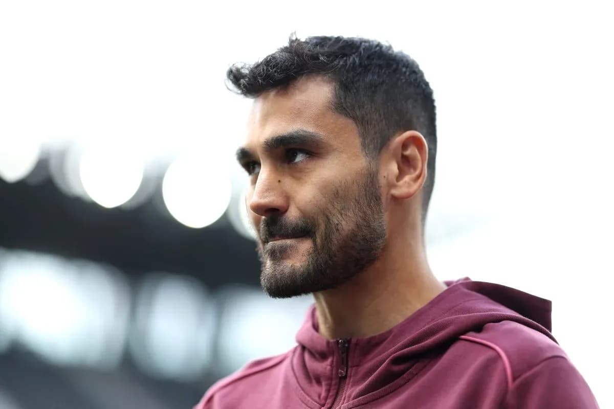 Player in maroon jacket at stadium entrance