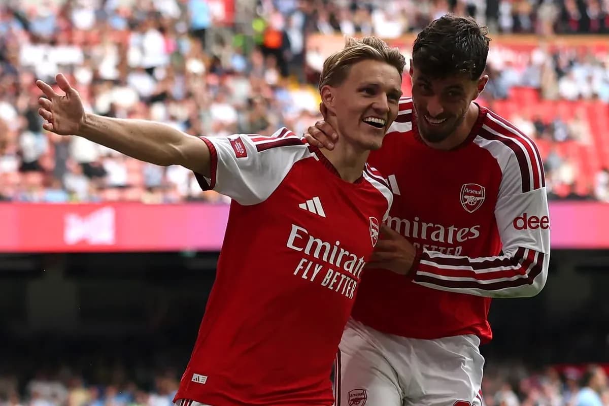 Two Arsenal players celebrating a goal together