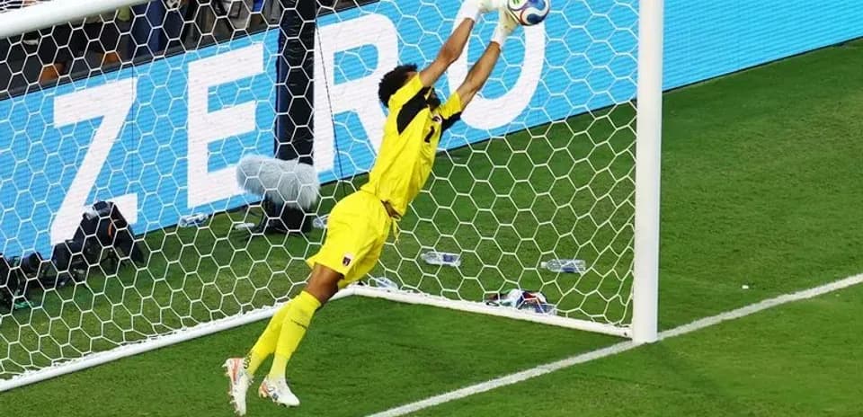 Goalkeeper diving to make a save in match