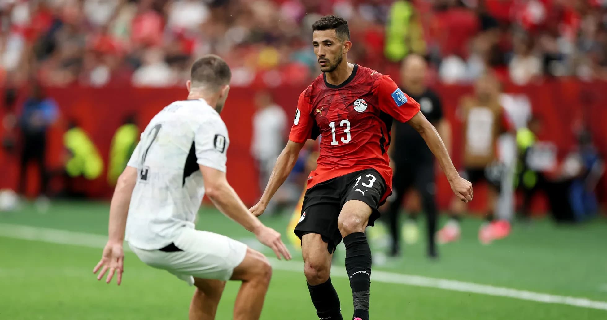 Egyptian player dribbling past opponent during match
