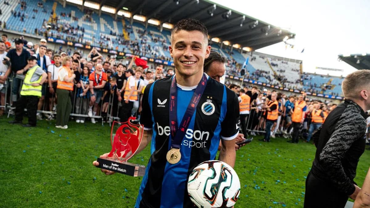 Player holding Man of the Match trophy on field