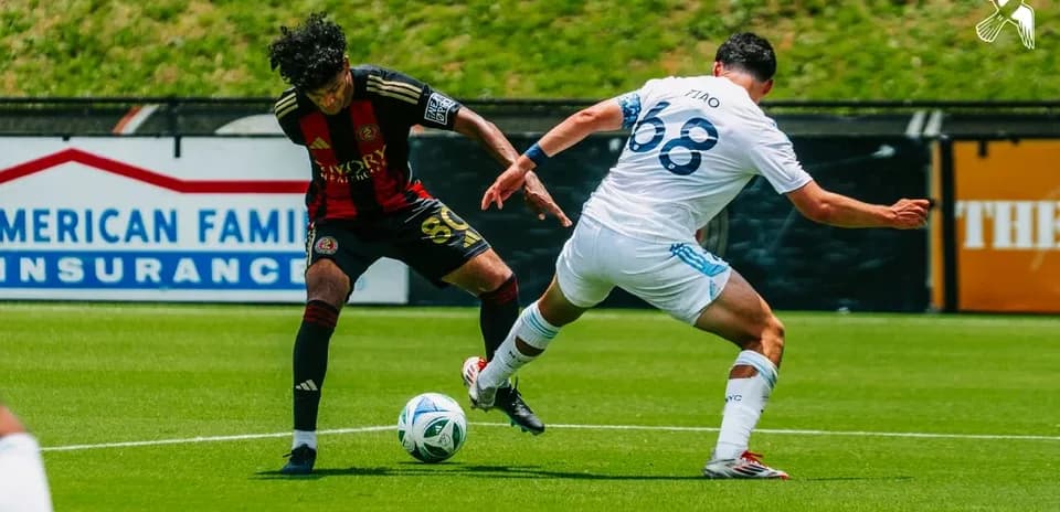 Player tackling opponent during Atlanta United II match