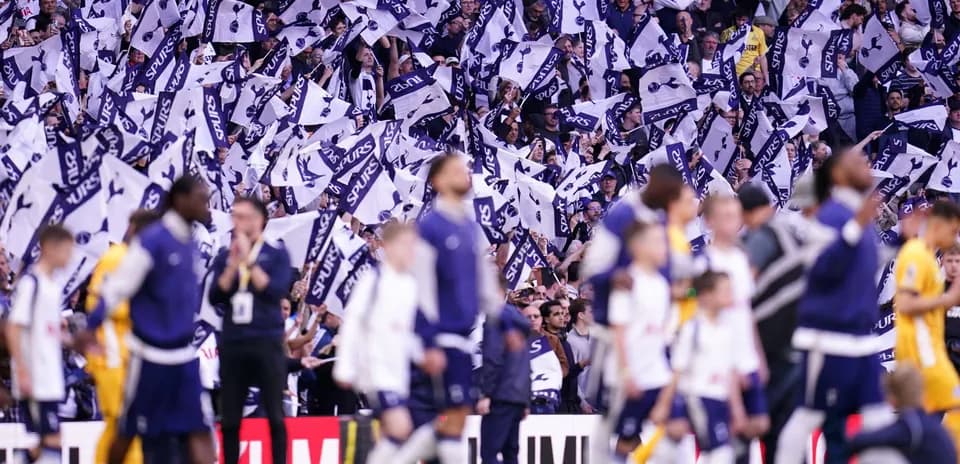 Fans waving flags during match at stadium