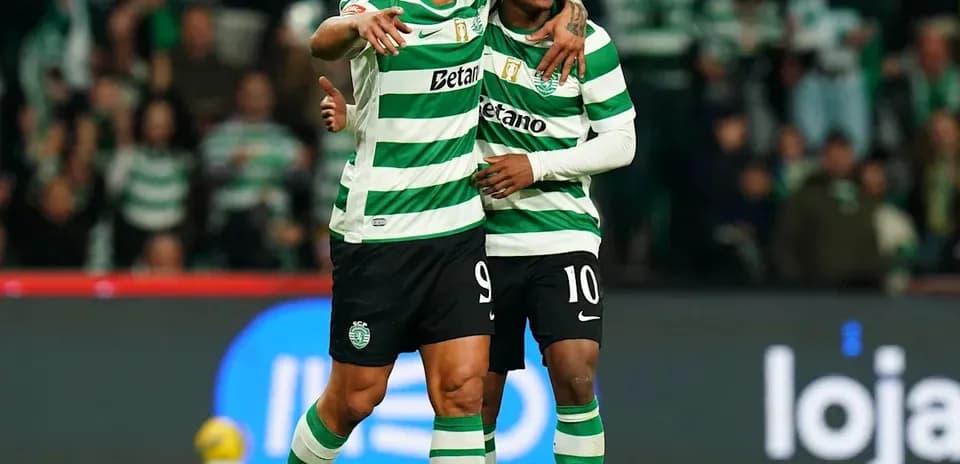 Two Sporting CP players celebrating on the pitch
