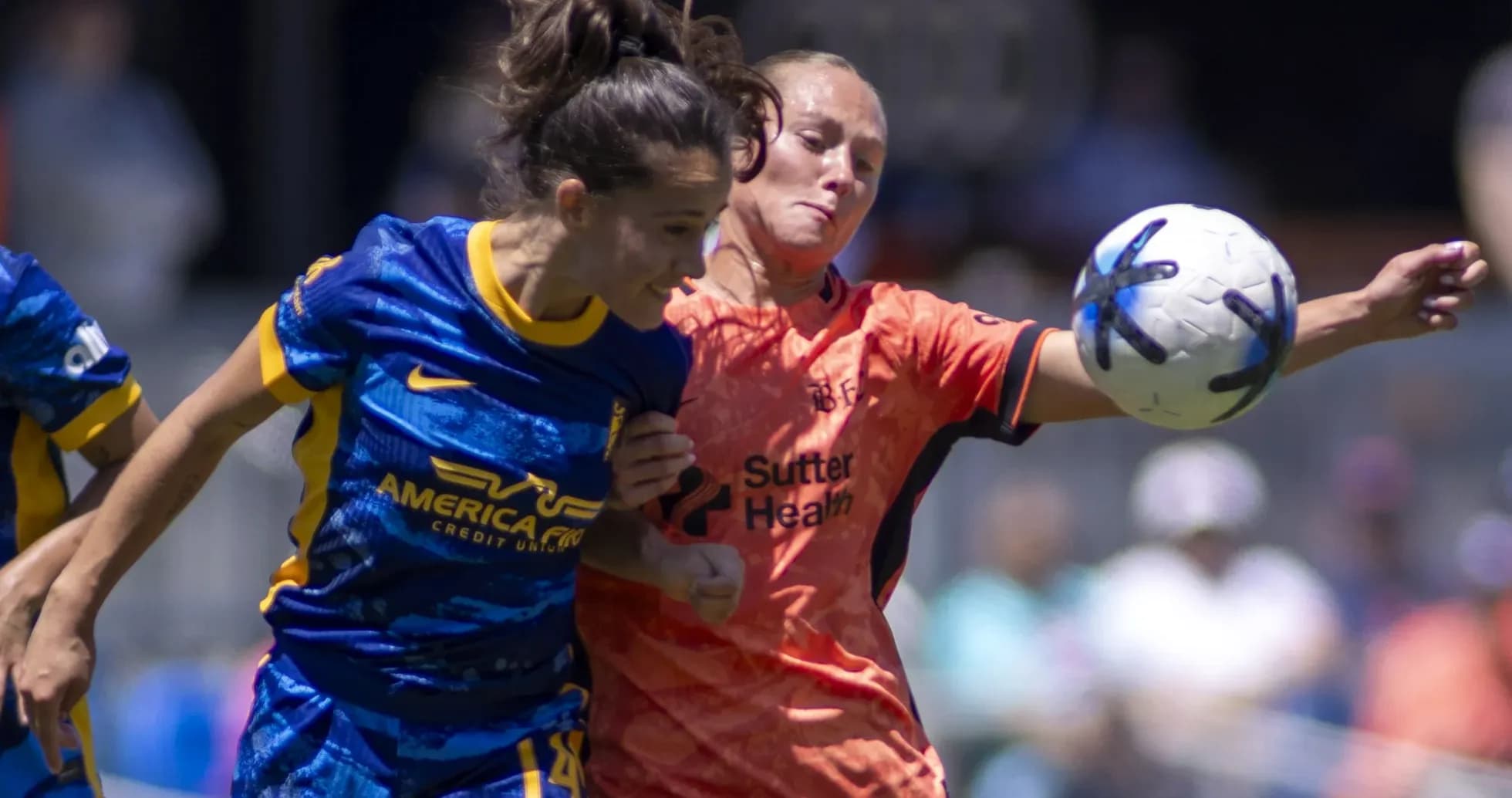 Players competing for the ball in NWSL match