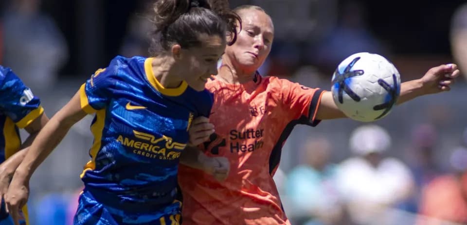 Players competing for the ball in NWSL match