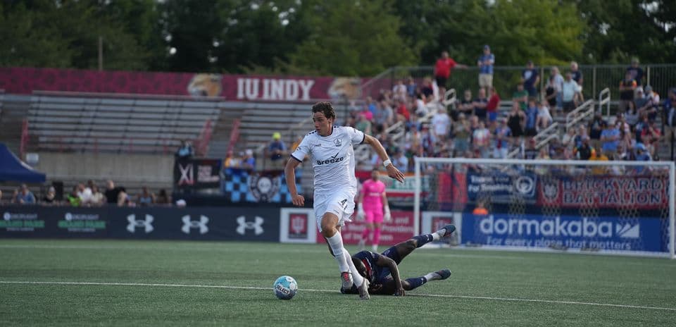 Player dribbling the ball during Indy Eleven match