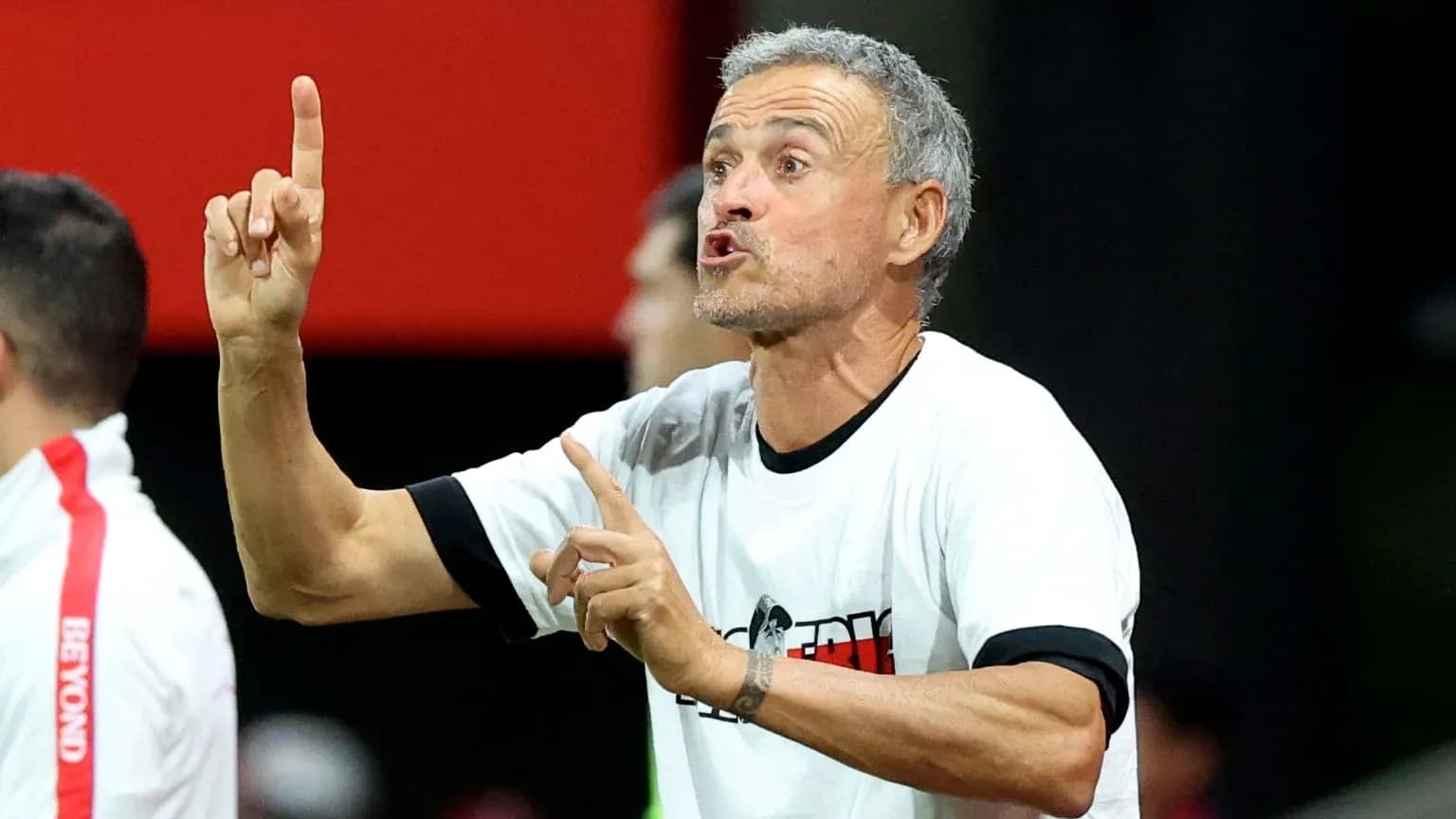Coach giving instructions from the sidelines during match