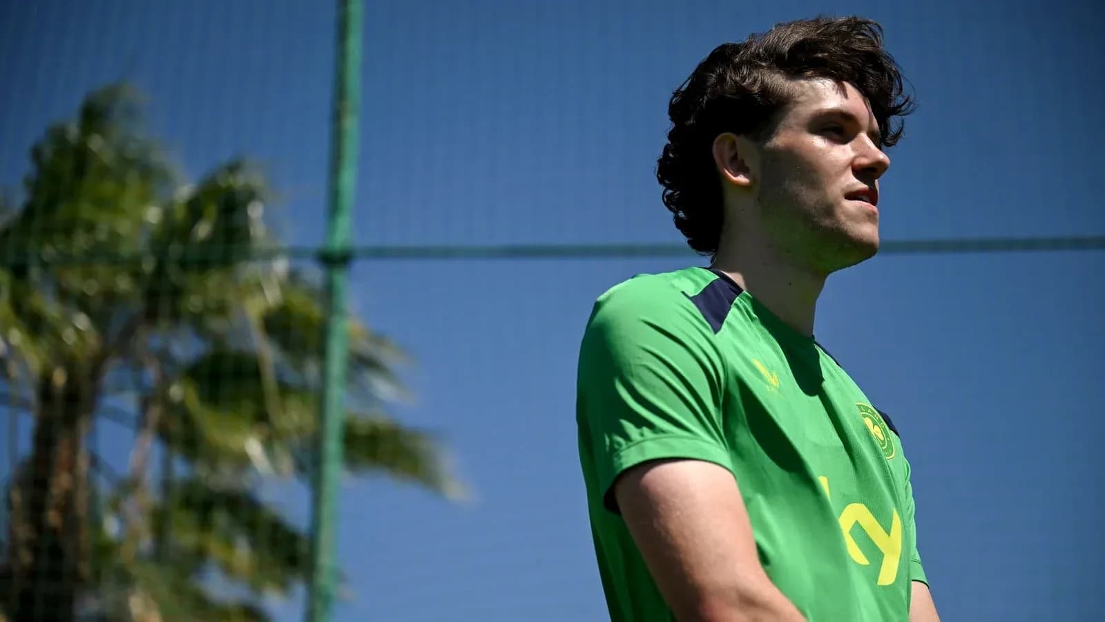 Player in green jersey at training facility
