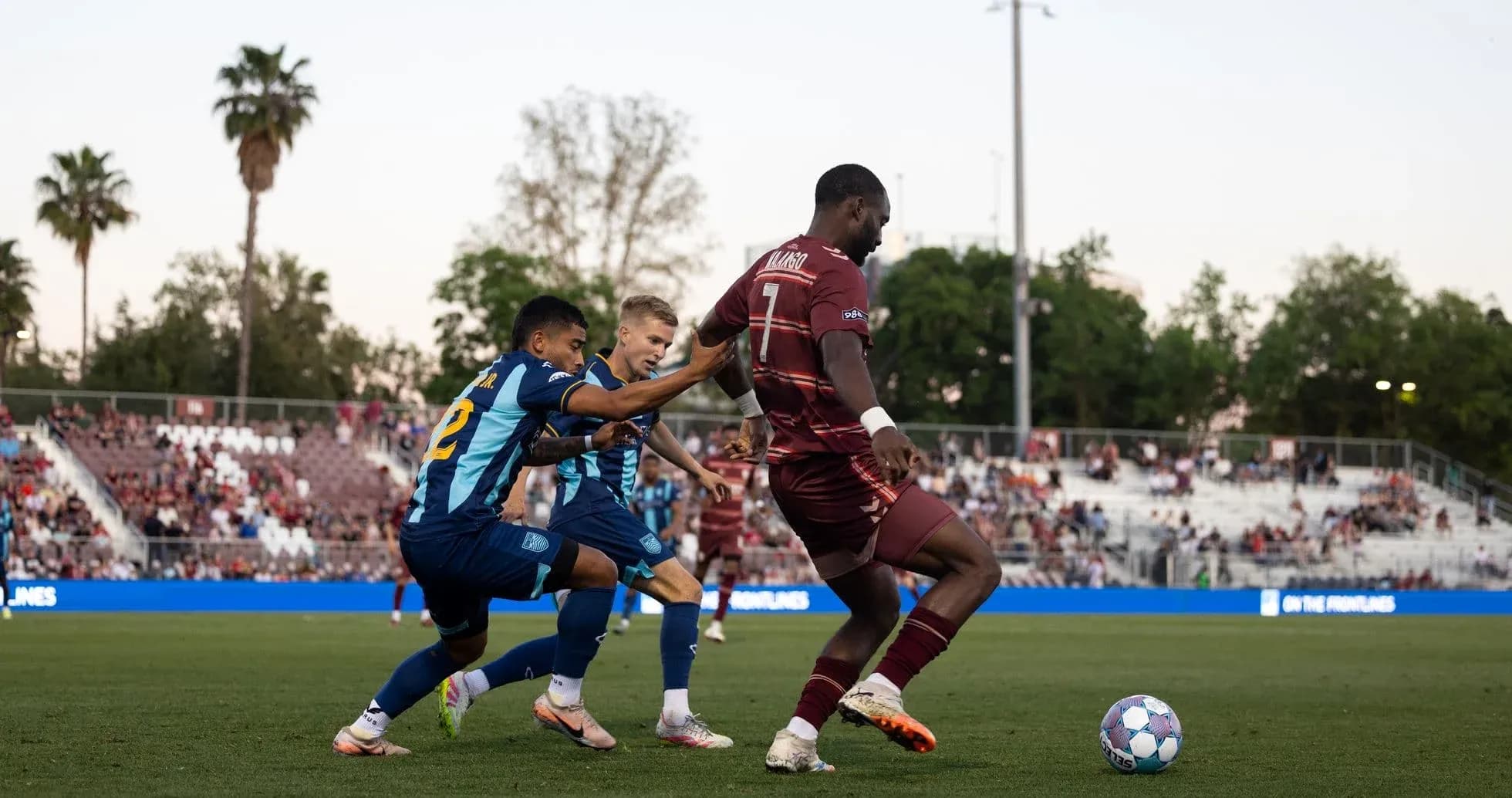 Player tackling opponent during Loudoun United match