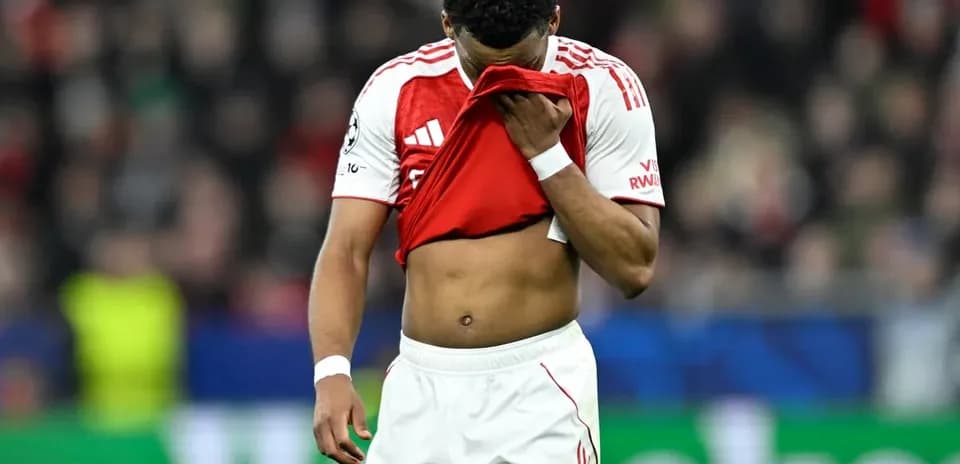 Player holding shirt to face on the pitch
