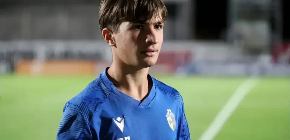 Player in blue jersey standing on the field
