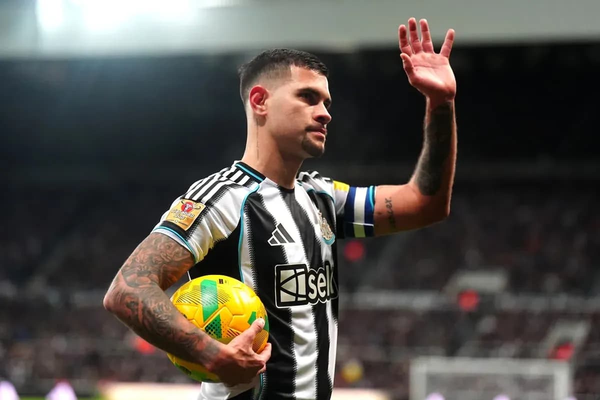 Player waving while holding a soccer ball