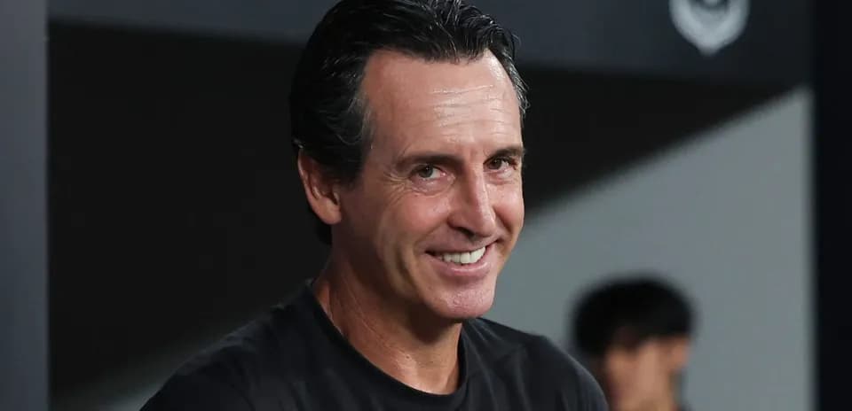 Coach smiling during match from the sidelines