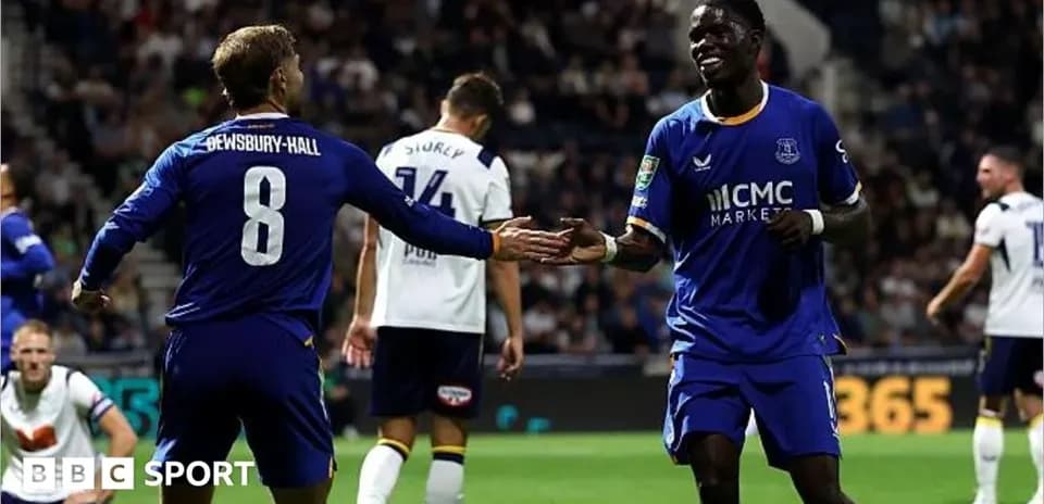 Two players celebrating a goal on the pitch